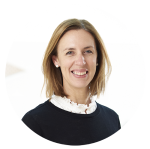 Celia Marston is smiling. She is wearing a navy jumper over a white collared shirt.