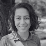 Woman in front of a tree smiling